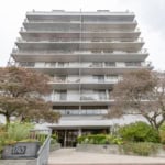 Spacious modern condominium building in Vancouver, BC with multiple balconies and well-maintained landscaping, ideal for real estate investments or living in desirable downtown area.