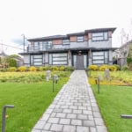 Modern contemporary house with sleek design, large windows, and landscaped front yard, available for sale or rent through Orca Realty Inc., Vancouver real estate experts.