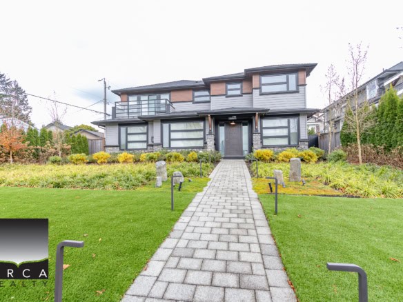 Modern contemporary house with sleek design, large windows, and landscaped front yard, available for sale or rent through Orca Realty Inc., Vancouver real estate experts.