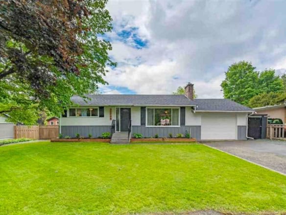 Bright single-family home with spacious front yard and lush greenery in a desirable neighbourhood, perfect for families and outdoor living near Orca Realty Inc. Vancouver.
