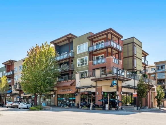 Modern multi-storey residential building with retail spaces on the ground floor, located in a vibrant urban neighbourhood in Orca Realty Inc. area.