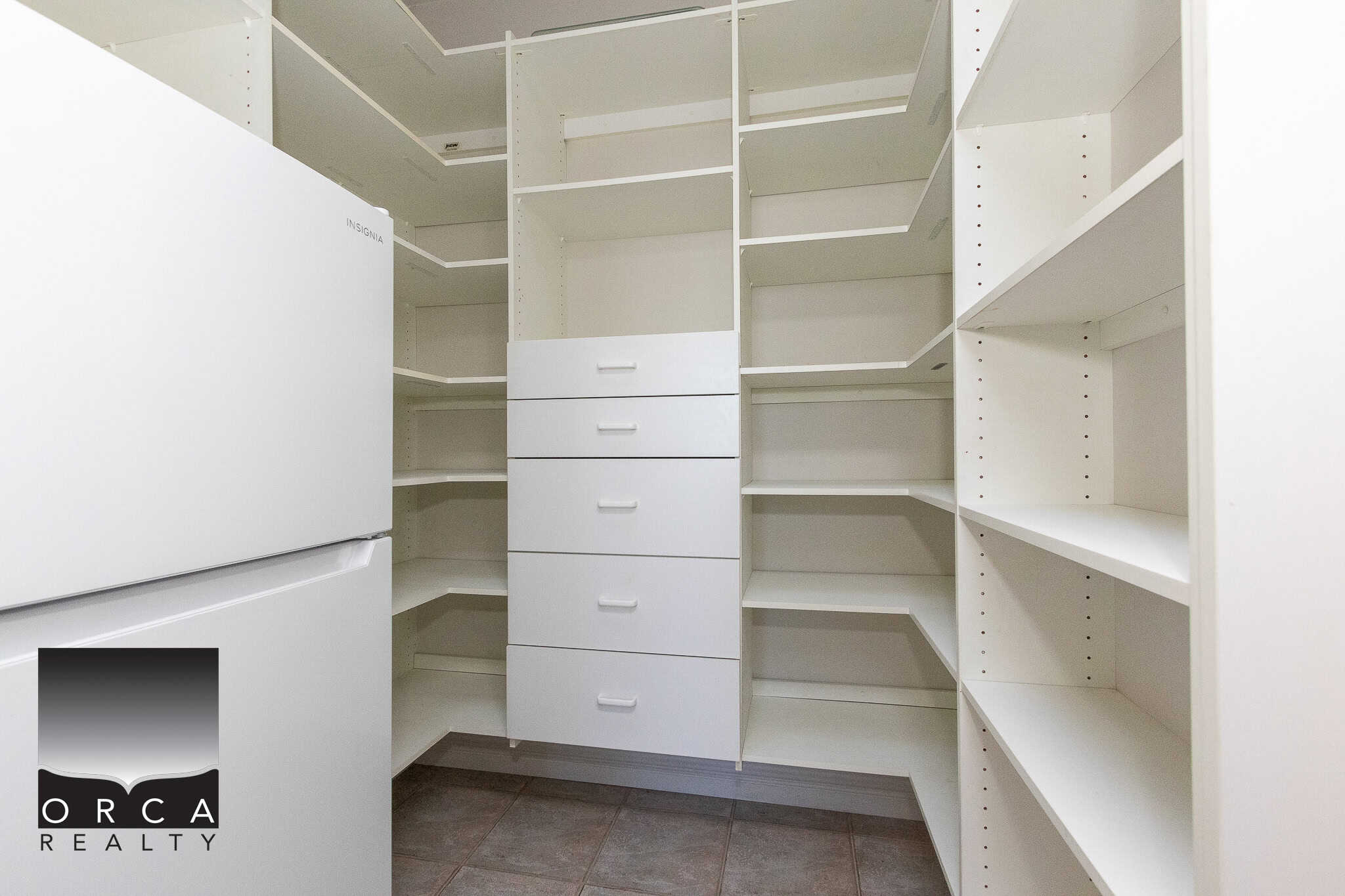 13 Spacious white walk-in closet with ample shelving and drawers, ideal for organized storage in a modern home, perfect for real estate listings in BC.