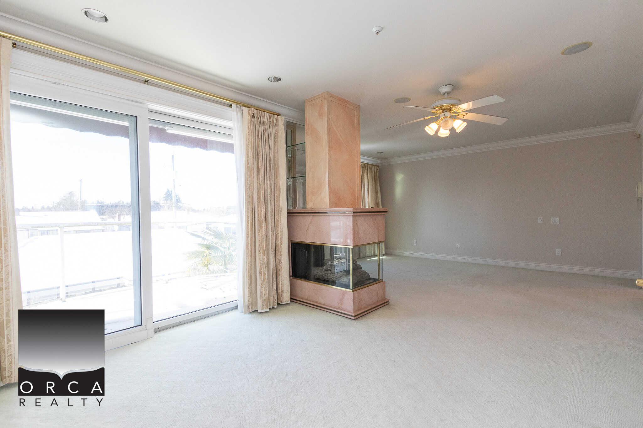 17 Spacious living room with large sliding glass doors, overlooking balcony, ideal for Vancouver Island real estate buyers.