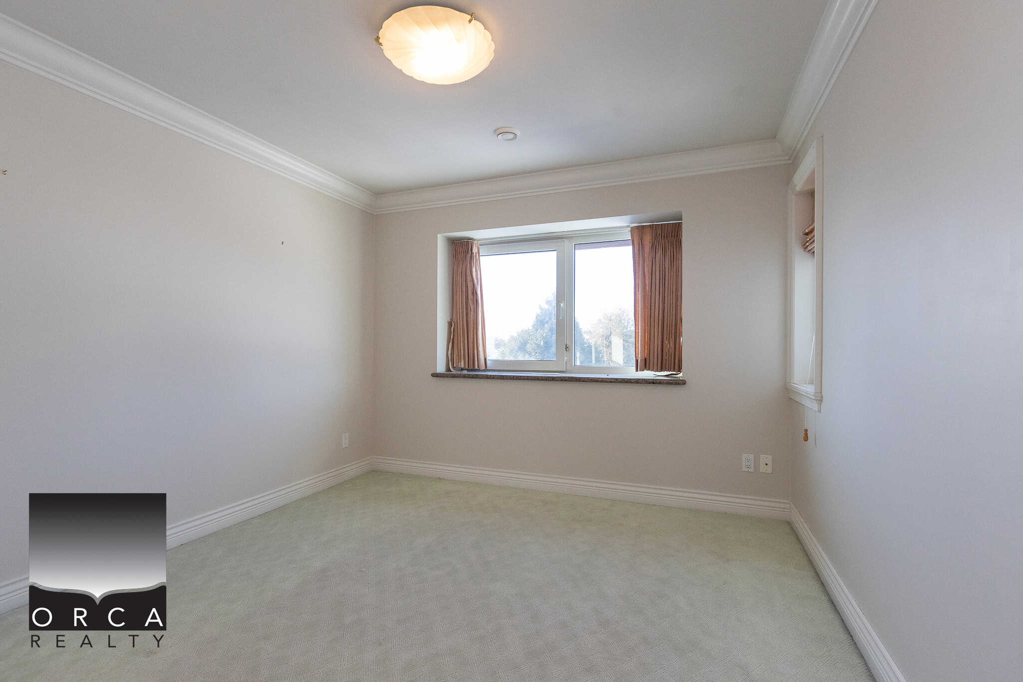21 Quiet bedroom with large window, natural light, beige walls, white crown molding, and soft carpet, ideal for Vancouver or Victoria homebuyers seeking comfort and spacious living.