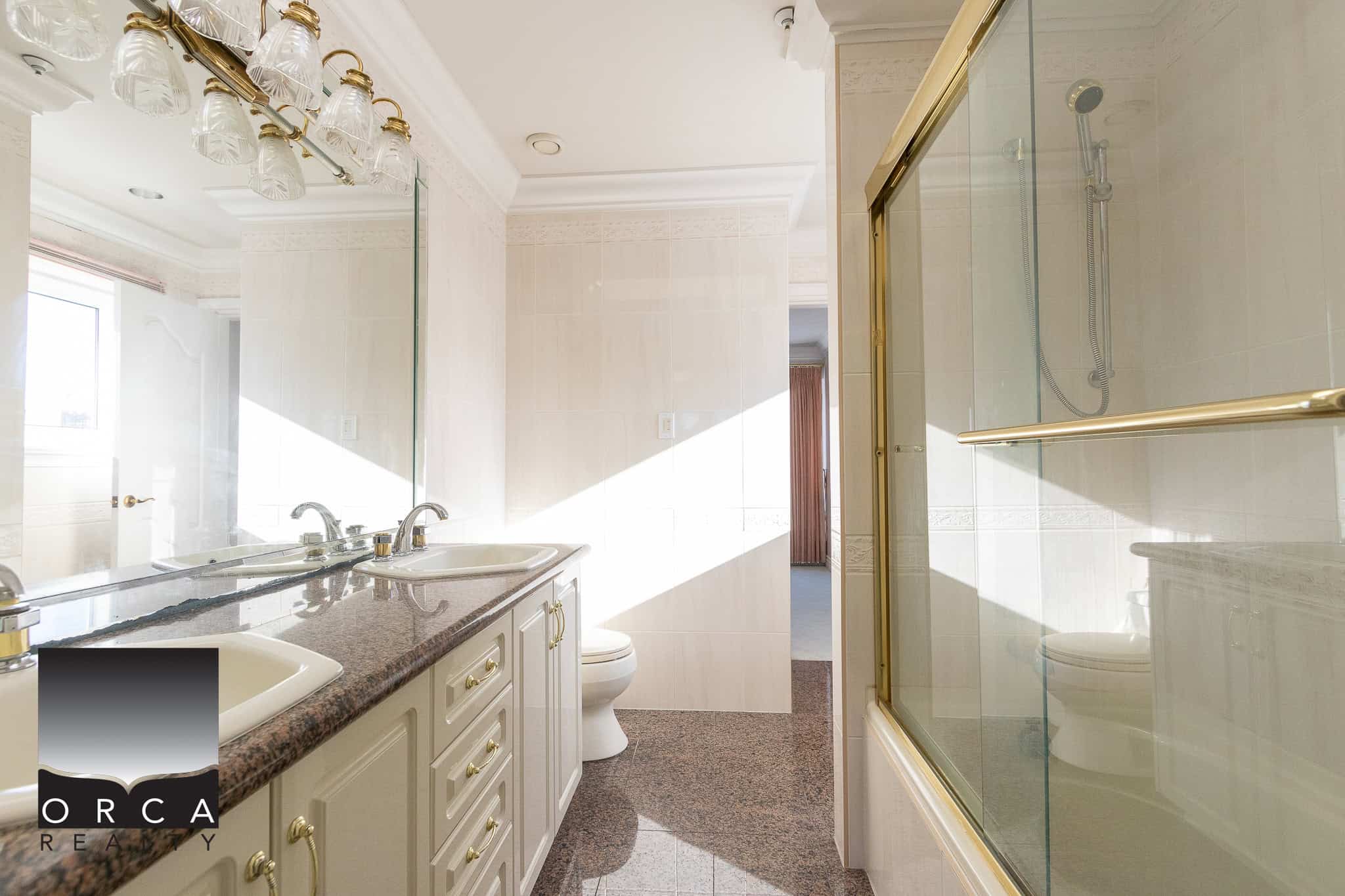 22 Spacious bathroom with double vanity, granite countertop, large mirror, and a glass-enclosed shower, perfect for luxury Vancouver real estate homes.
