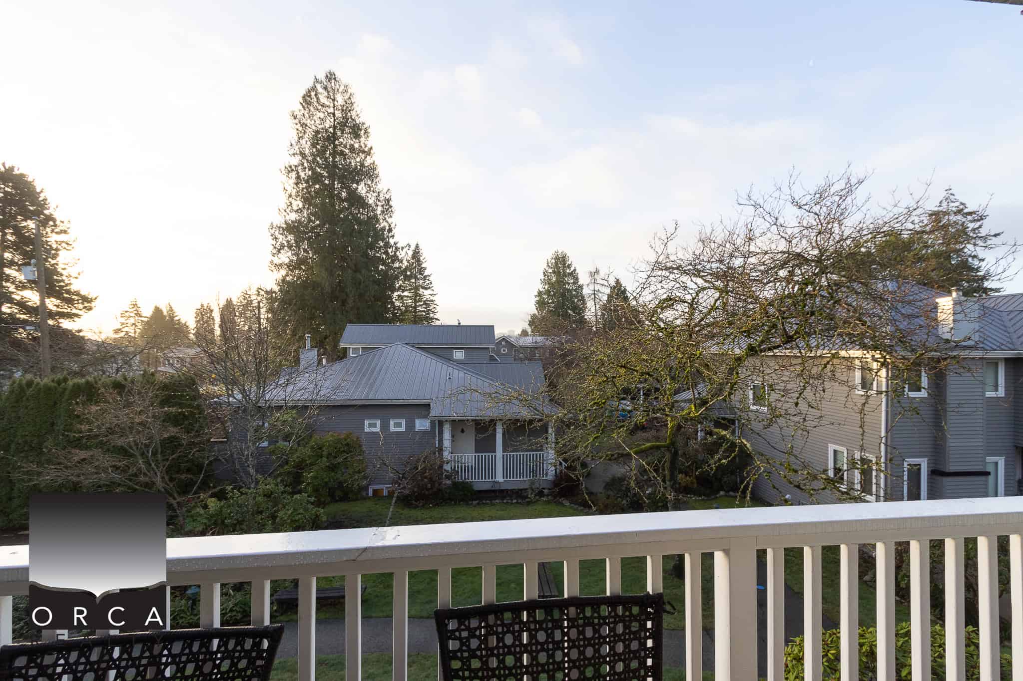 Picturesque neighbourhood scenery with cozy houses and mature trees, ideal for real estate investment or home buying in BC's vibrant markets.