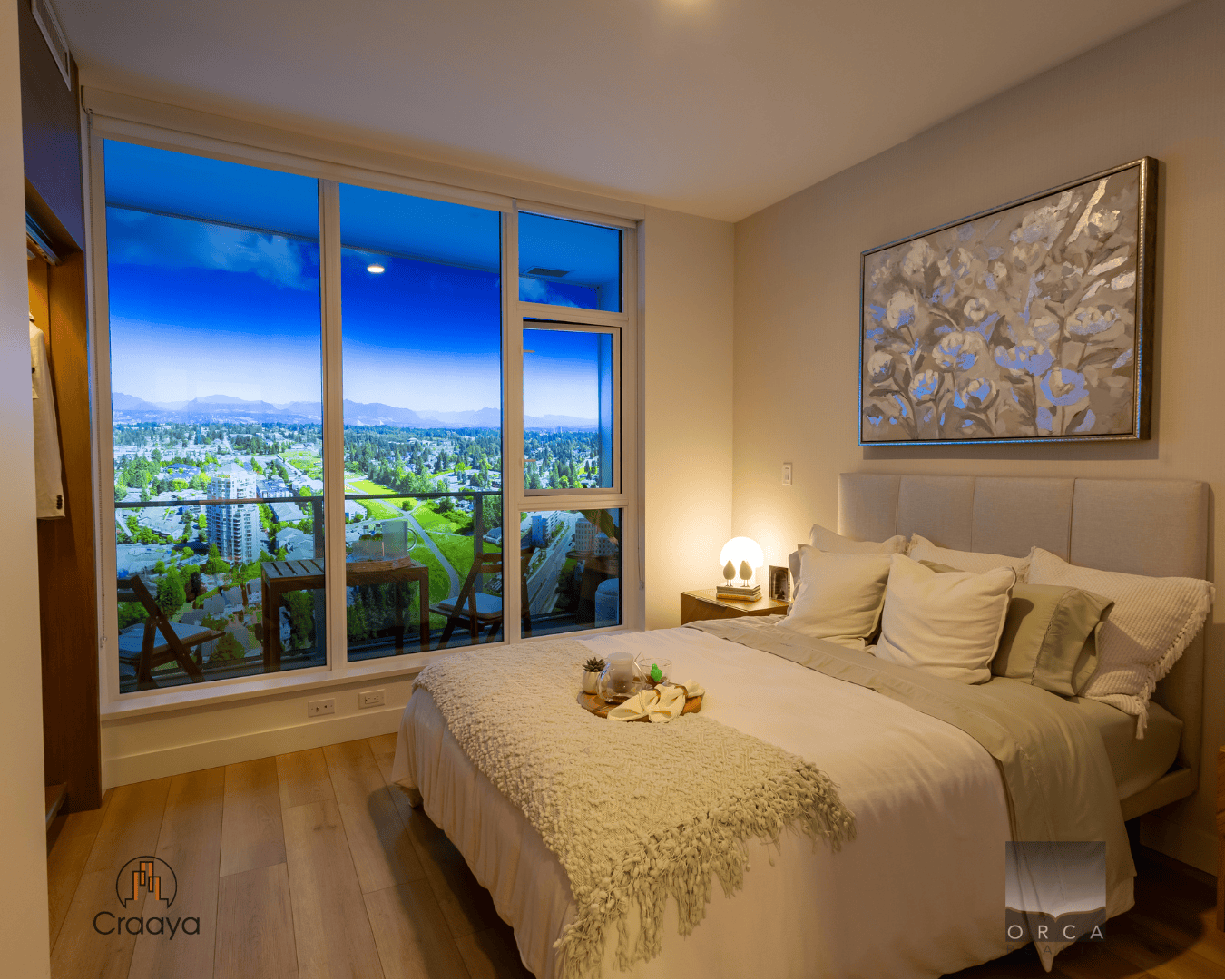 4 Balcony view of cityscape and mountains at night from a modern bedroom in a high-rise apartment in Vancouver, BC with large floor-to-ceiling windows and stylish decor for luxury real estate listing.