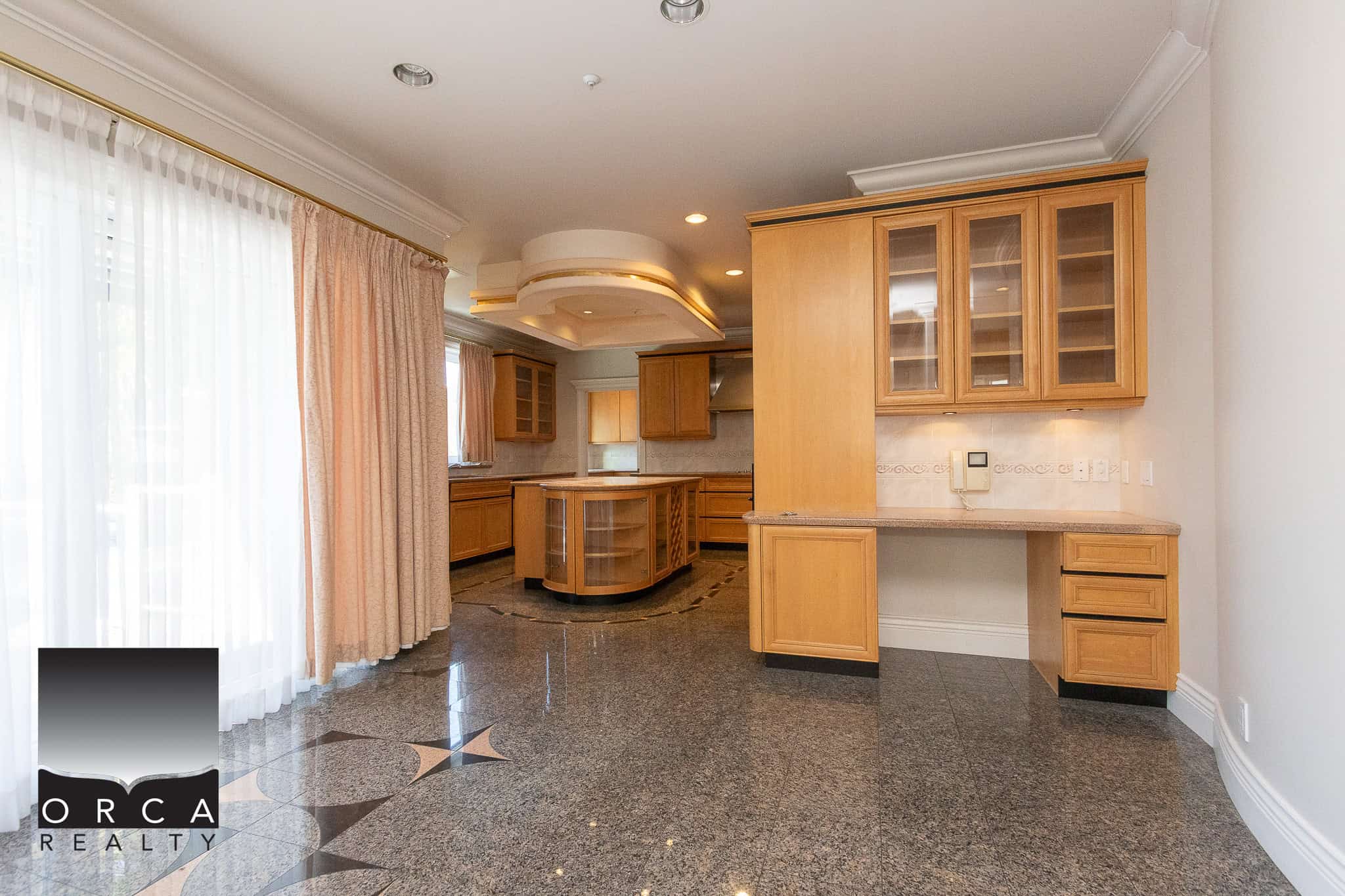 6 Spacious kitchen with custom wooden cabinetry, granite countertops, and elegant flooring, ideal for Vancouver Island real estate buyers seeking upscale homes.