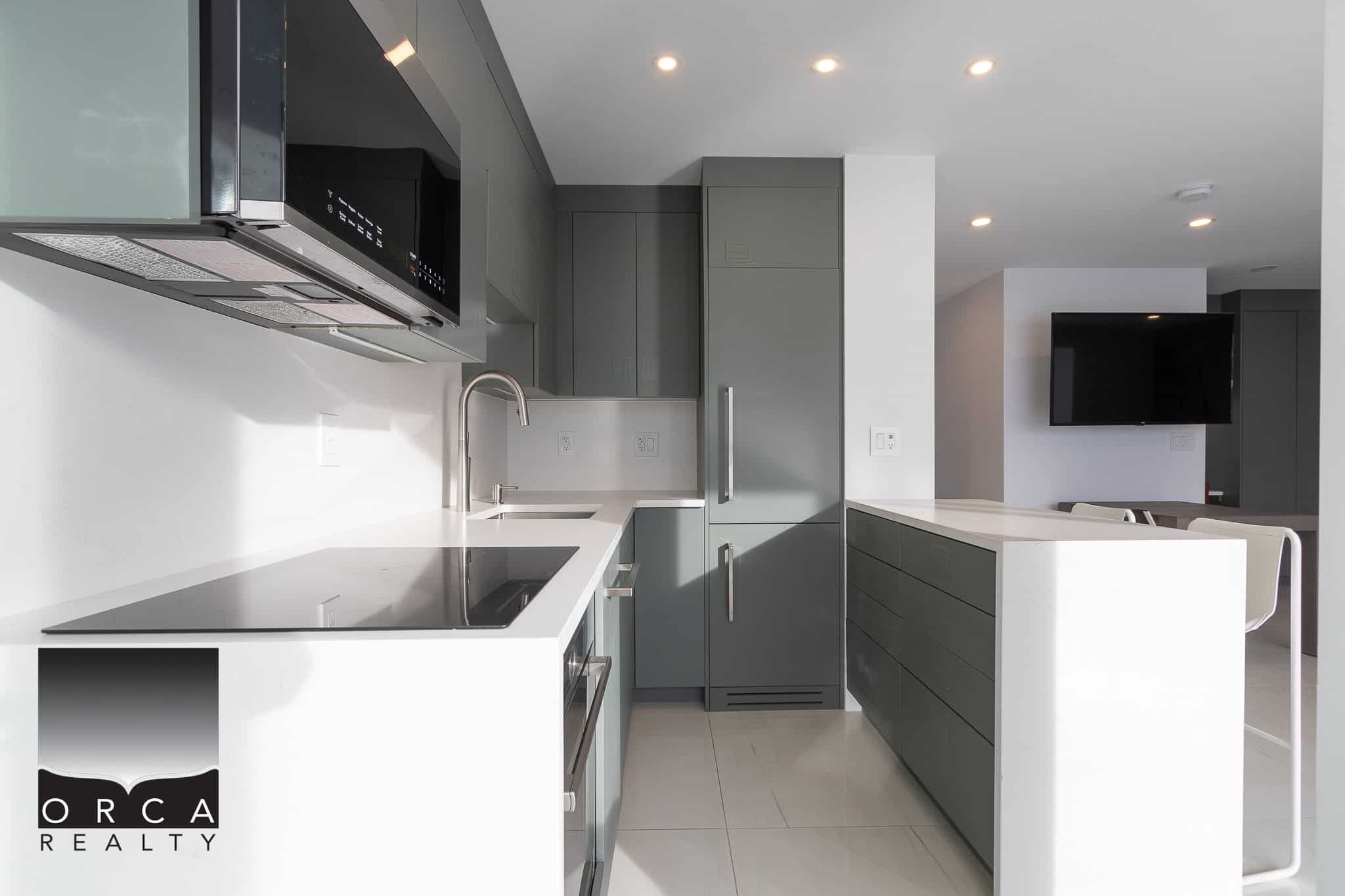 Modern grey and white kitchen interior with sleek cabinetry and appliances, ideal for Vancouver real estate listings and property sales; perfect for luxury apartment listings and open-concept homes.