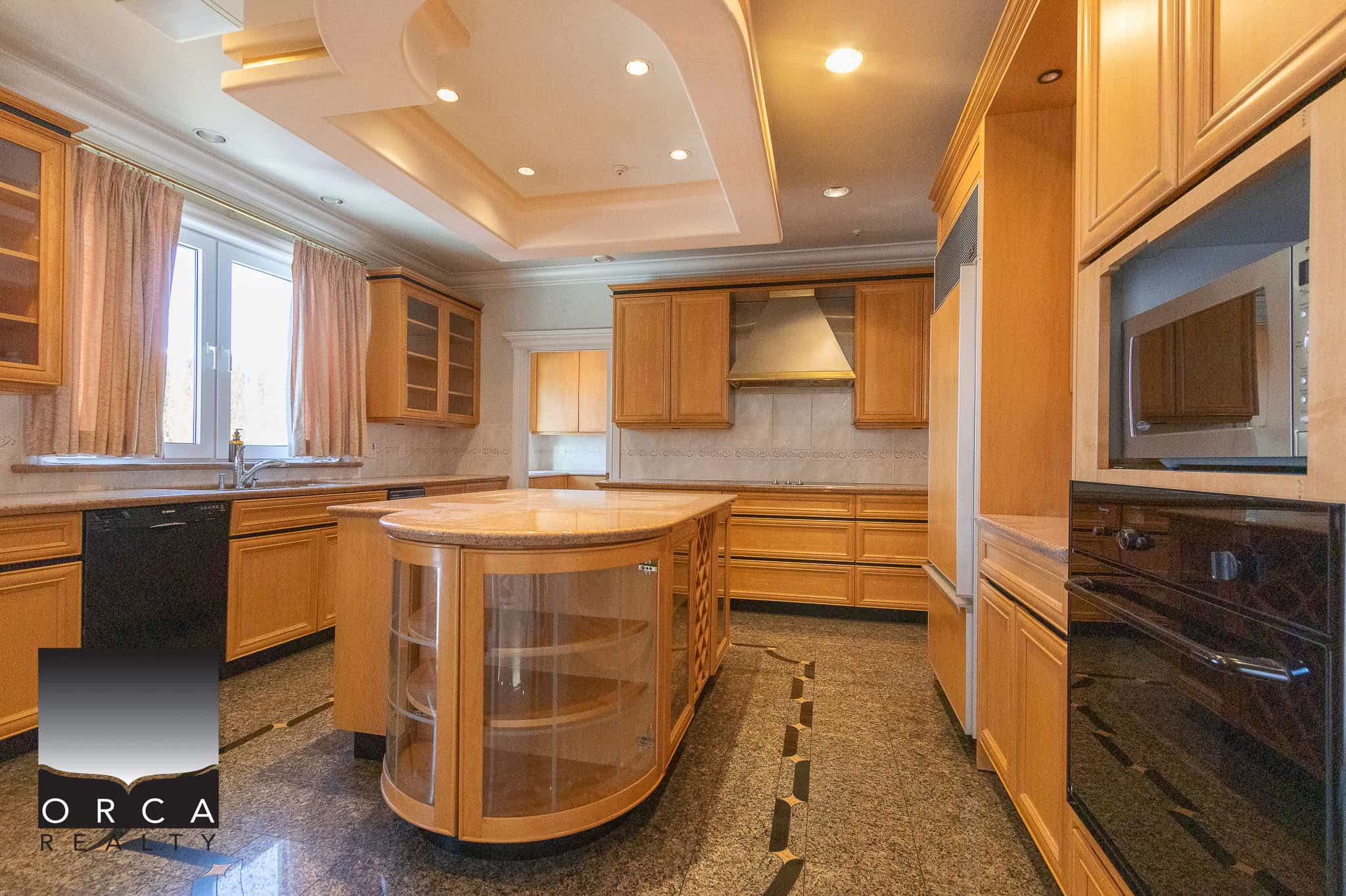 7 Spacious modern kitchen with wooden cabinetry, granite countertops, and stainless steel appliances, perfect for Vancouver Island luxury homes and real estate investments.