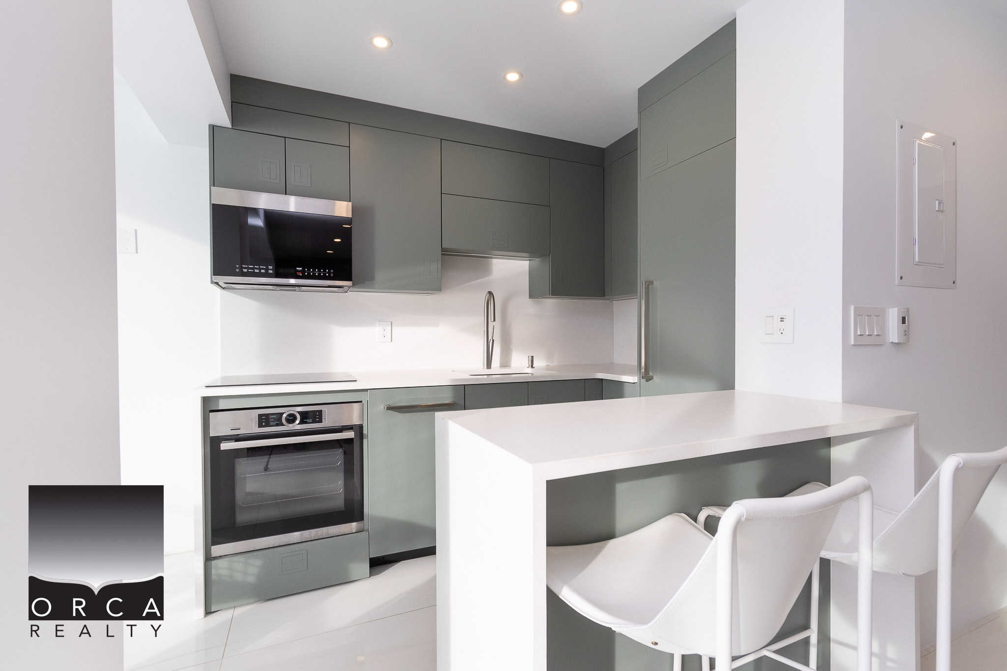 Modern grey and white kitchen with sleek appliances, minimalist design, and ample counter space, perfect for Vancouver real estate and homebuyers looking for contemporary interiors.