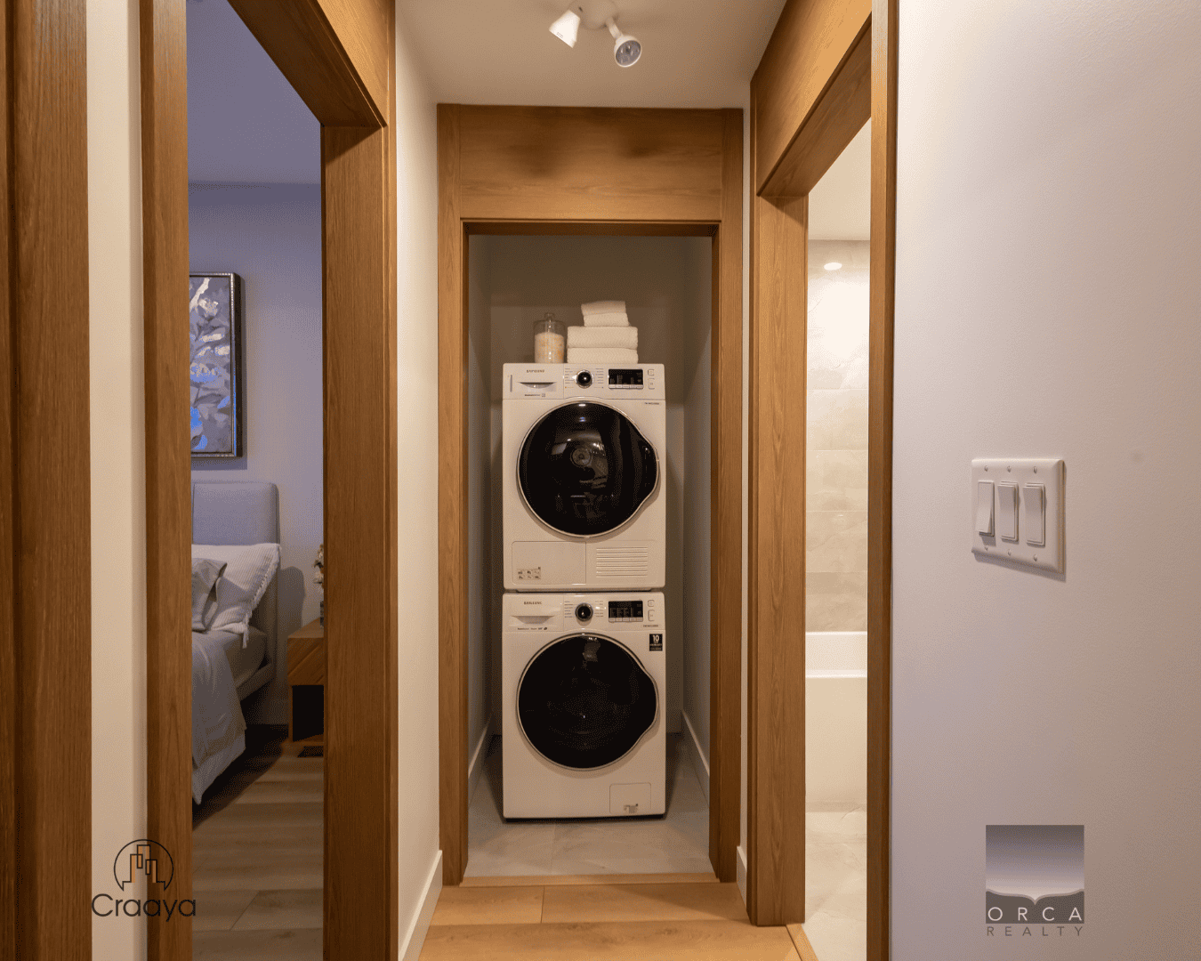 8 Efficent stackable washer and dryer unit in a modern laundry nook with wood trim in a contemporary home in BC.