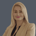 Professional real estate agent portrait, woman with blonde hair and business attire, expertise in Vancouver and Lower Mainland property market, trusted by Orca Realty Inc.