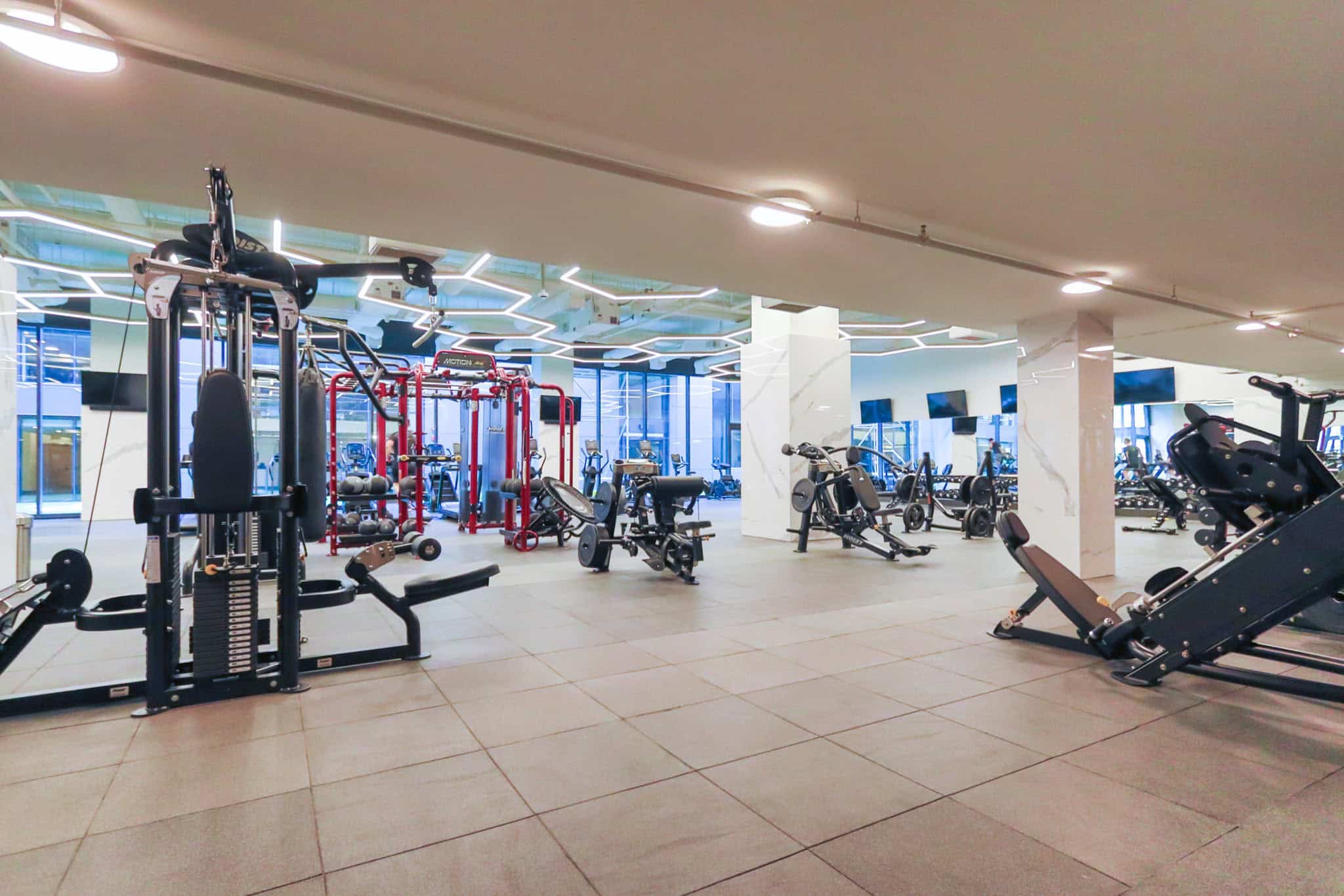 Modern commercial gym with state-of-the-art fitness equipment and bright interior, perfect for health-conscious clients seeking premium wellness facilities.