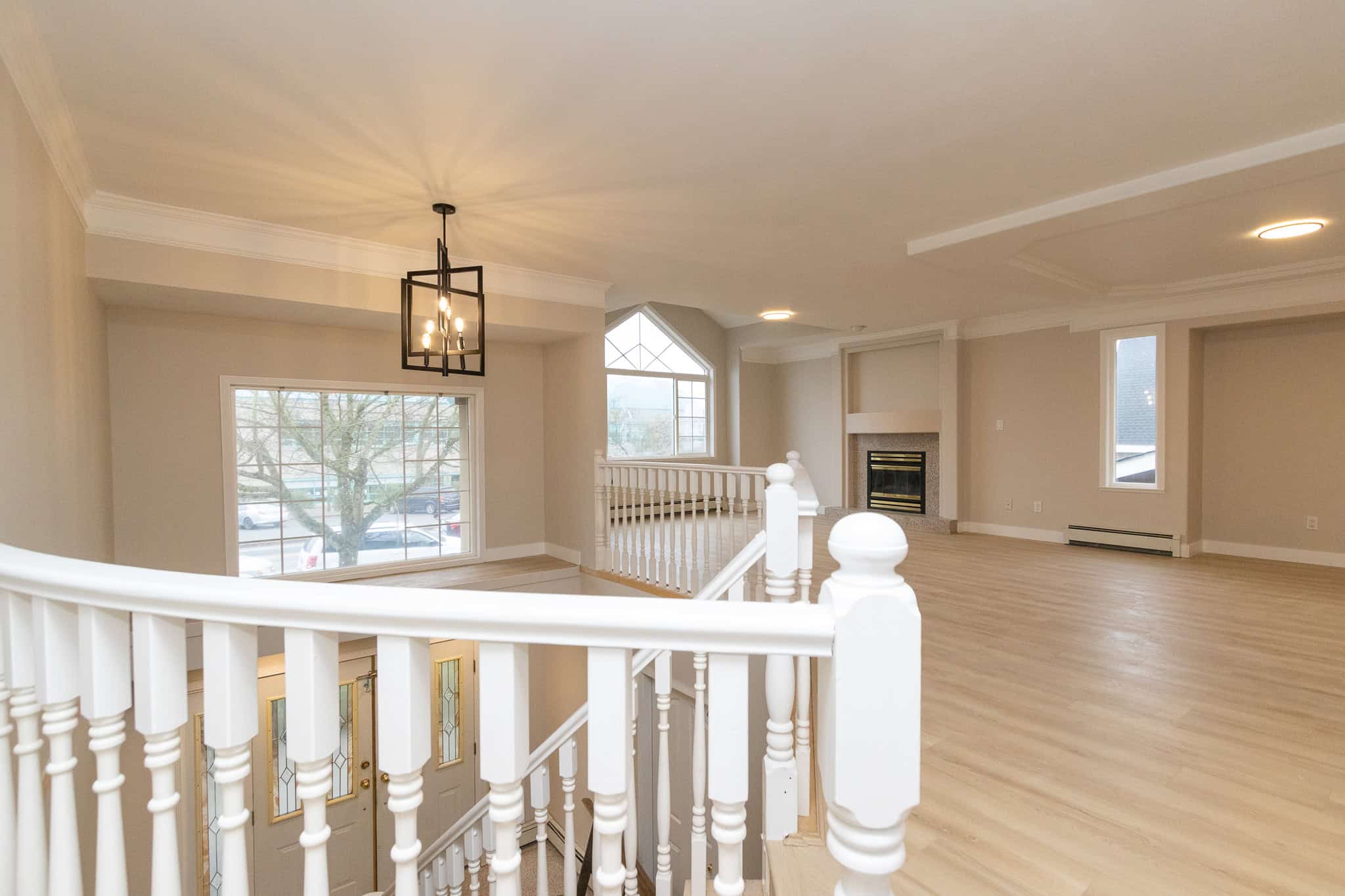 IMG_4363 Spacious open-concept living area with bright natural light, hardwood floors, fireplace, and modern design, perfect for Vancouver real estate enthusiasts.