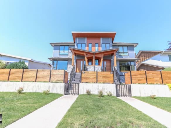 Modern luxury home exterior in Vancouver with contemporary design, large windows, and landscaped front yard showcasing Orca Realty Inc.'s expert property listings in BC.