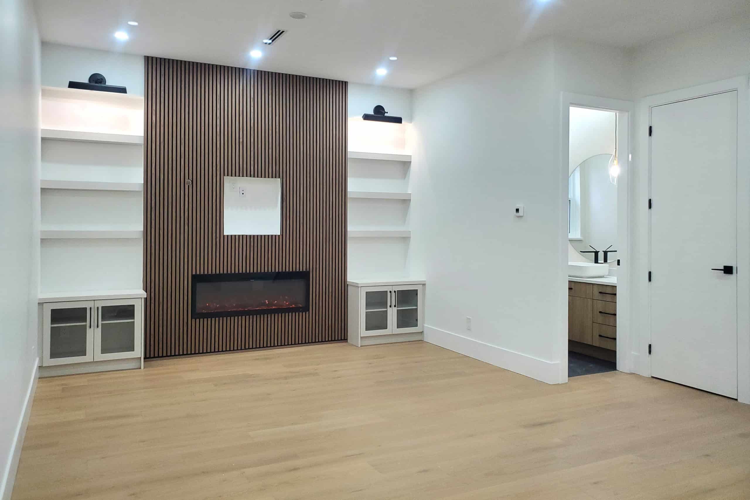 10 Spacious living room with modern fireplace and built-in shelving, laminate flooring, and open design in a contemporary Vancouver home.