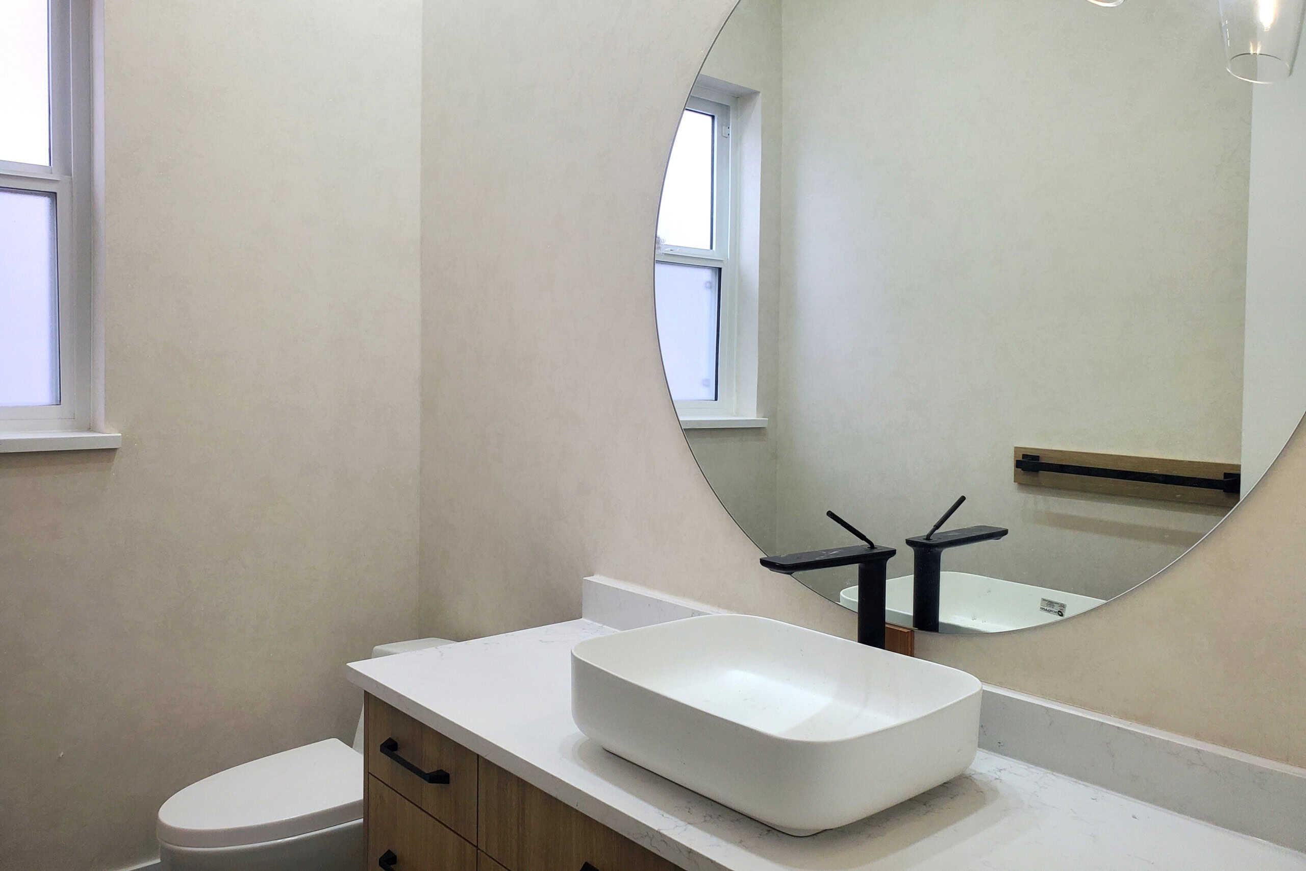 11 Modern bathroom with vessel sink, black faucet, and minimalistic design at Orca Realty Inc. showcasing upscale real estate interiors in Canada.