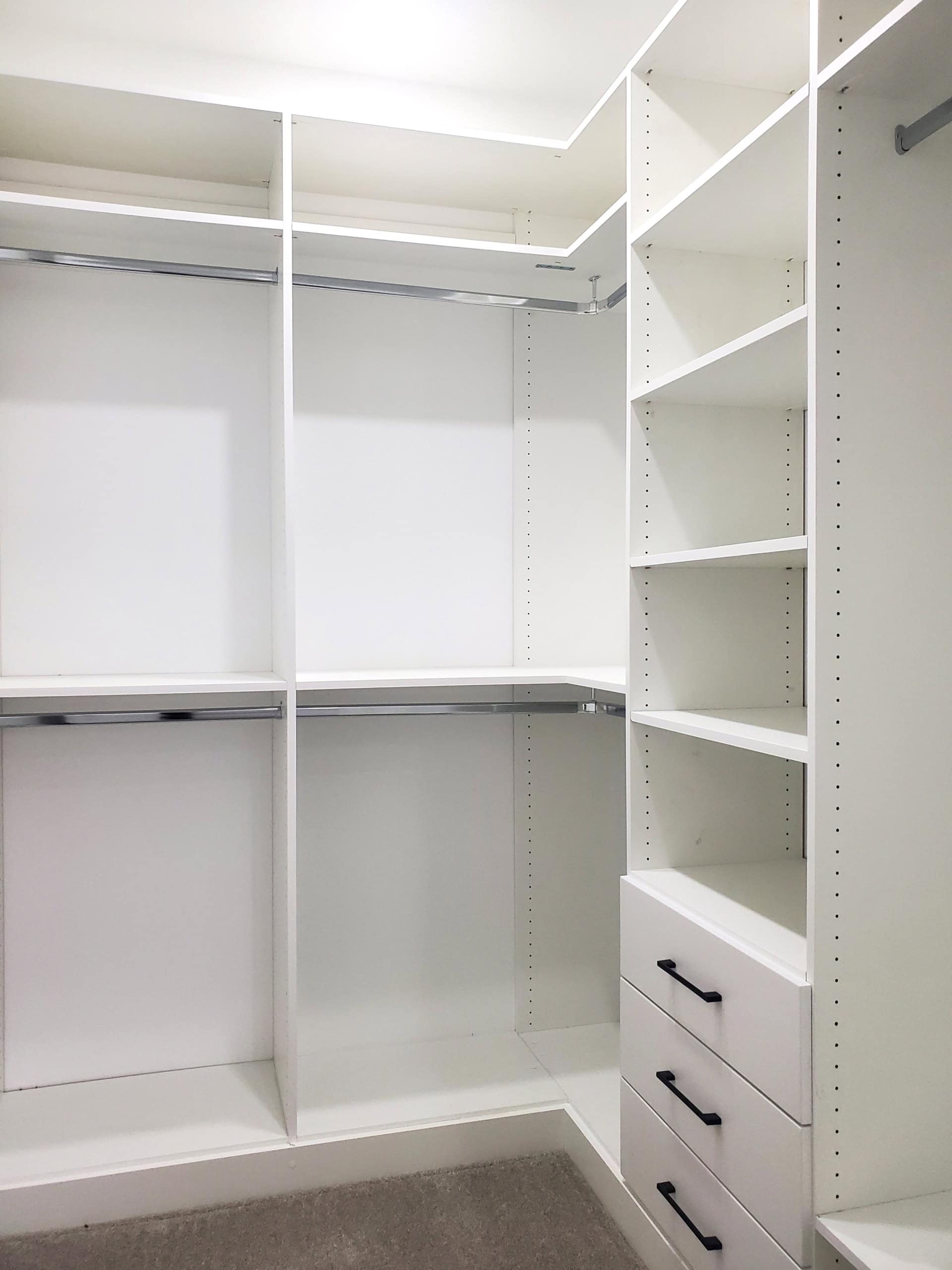 15 Spacious walk-in closet with custom white shelving and ample storage space, ideal for home organization and real estate staging in Vancouver, BC.