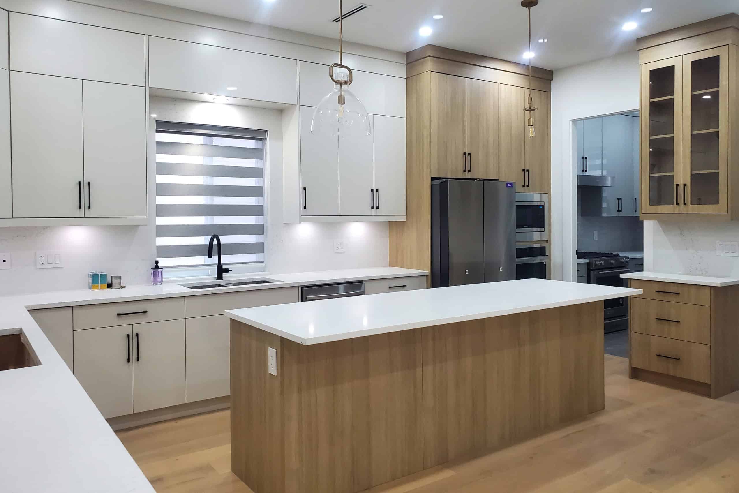 2 Modern kitchen with white and wood cabinetry, stainless steel appliances, and ample counter space in a contemporary home.