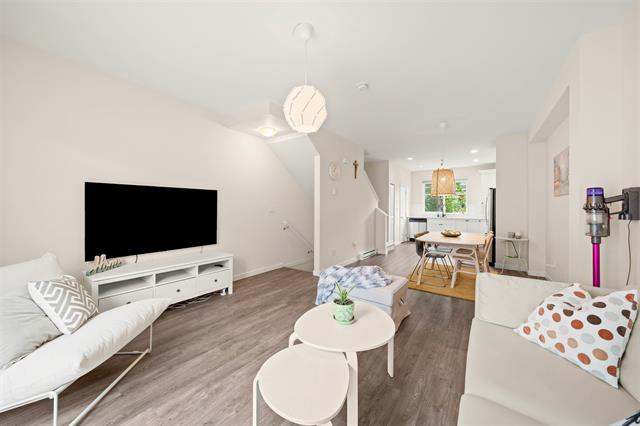 Bright and modern open-concept living room and dining area in a stylish home listed by Orca Realty Inc. in Victoria, BC, showcasing contemporary décor and spacious interior design.