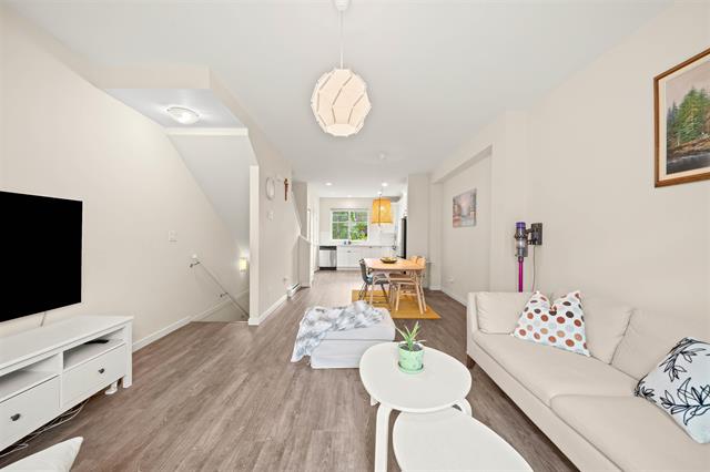 Modern living room interior with white walls and contemporary furniture, open concept design, cozy sofa, and stylish lighting, showcasing a bright and inviting home environment for Vancouver real estate.