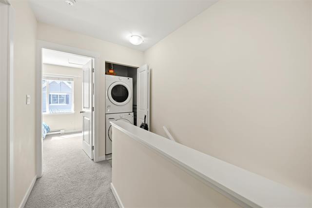 Washer and dryer in laundry room at Orca Realty Inc. property, showcasing modern home amenities.