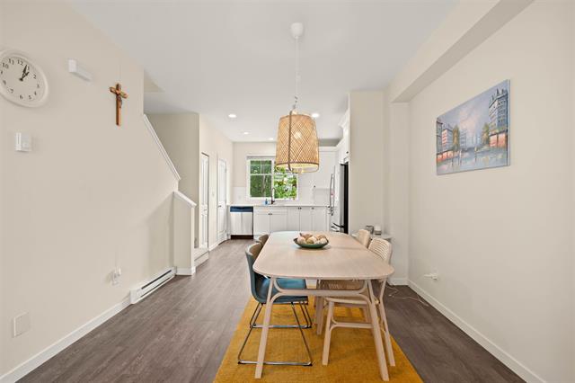 Modern dining area in a bright, open-concept home with stylish furniture and contemporary decor, perfect for family meals and gatherings.