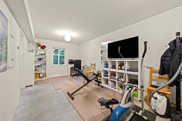 Home gym with exercise equipment and entertainment area, indoor workout space, fitness and leisure room, orca realty inc.