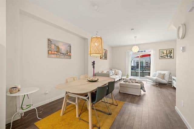 Bright, modern living room and dining area in a Calgary condo, featuring stylish furniture, natural light, and contemporary décor, ideal for make your home in Alberta.