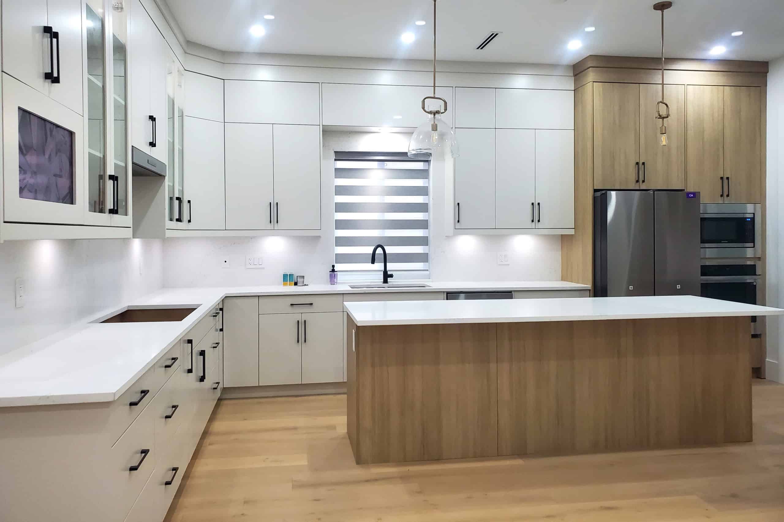 3 Modern kitchen with white and wood cabinetry, quartz countertops, and stainless steel appliances, ideal for Vancouver and surrounding areas real estate.