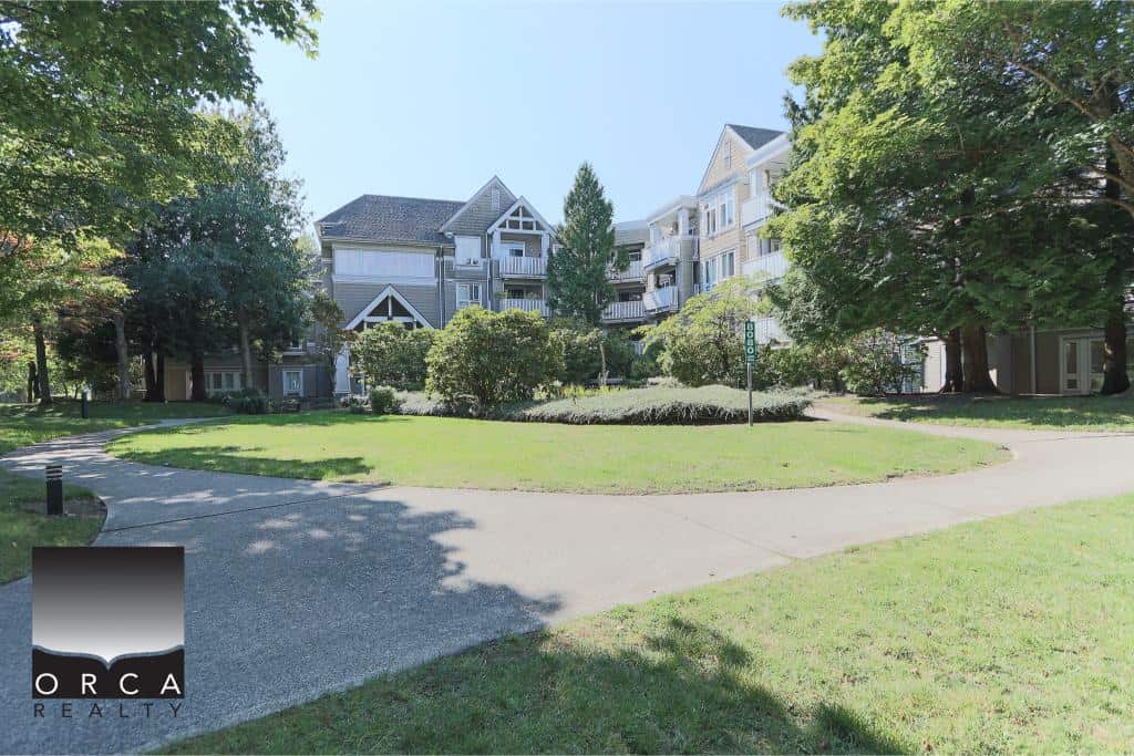 Modern multi-unit residential complex with scenic landscaped gardens and walking paths in a peaceful urban setting in Victoria, BC. Perfect for real estate investment or rental opportunities in BC.