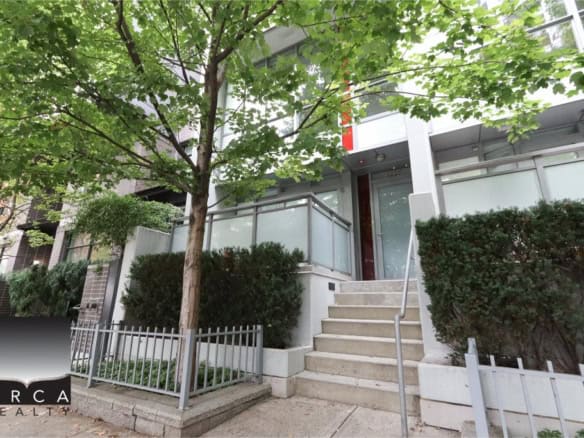 Modern Condo Building Entrance with Tree and Greenery in Vancouver, BC.