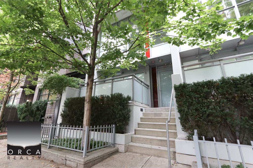 Modern Condo Building Entrance with Tree and Greenery in Vancouver, BC.