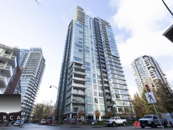 Modern high-rise residential tower in Downtown Vancouver featuring glass exterior, spacious balconies, and prime real estate location for luxury condo living.