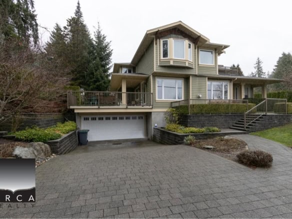 Spacious multi-level residential home with large driveway, manicured landscaping, and inviting outdoor decks in a serene neighbourhood. Perfect for family living and entertaining.