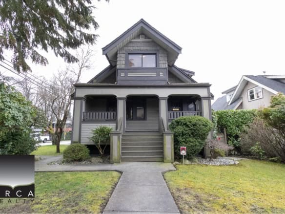 Victorian style home for sale in Victoria BC by Orca Realty, featuring a charming porch, lush landscaping, and classic architectural details, ideal for families and investors.