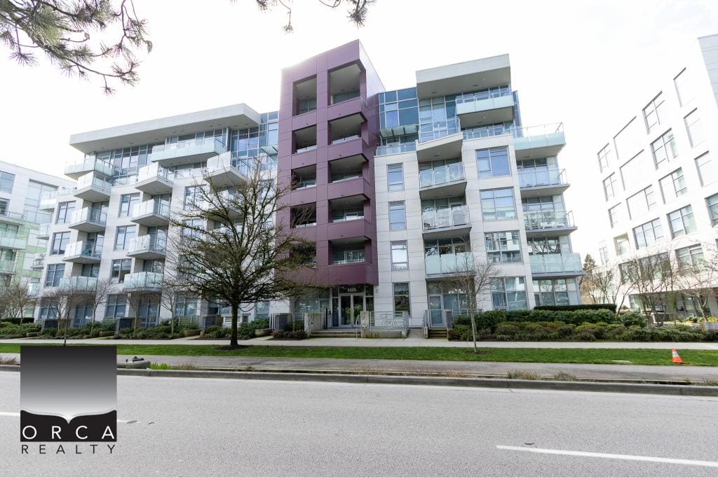 Contemporary multi-family residential apartment building with modern architecture, glass balconies, and lush landscaping in Vancouver, BC. Ideal for real estate investment and property management in British Columbia.