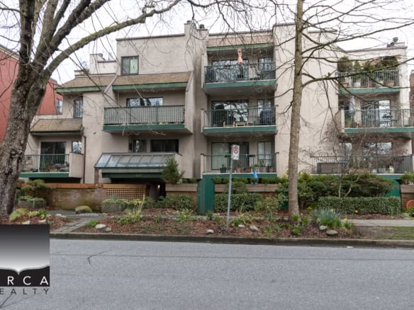 Spacious multi-unit residential building with balconies and landscaped front yard in Vancouver, BC. Perfect for real estate investment or family living in a vibrant Vancouver neighbourhood.