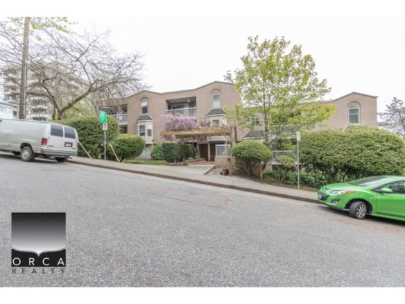 Elegant multi-family residential building with lush landscaping in Vancouver, BC, showcasing modern architecture and vibrant greenery, available through Orca Realty Inc.