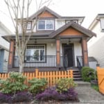 Charming two-story home for sale by Orca Realty Inc. located in a vibrant neighbourhood, featuring a cozy front porch, well-maintained garden, and modern architectural design.