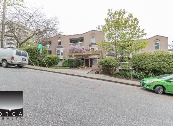 Spacious residential building with lush landscaping and parking available in a quiet neighbourhood, ideal for Vancouver-area homeowners seeking comfort and convenience.