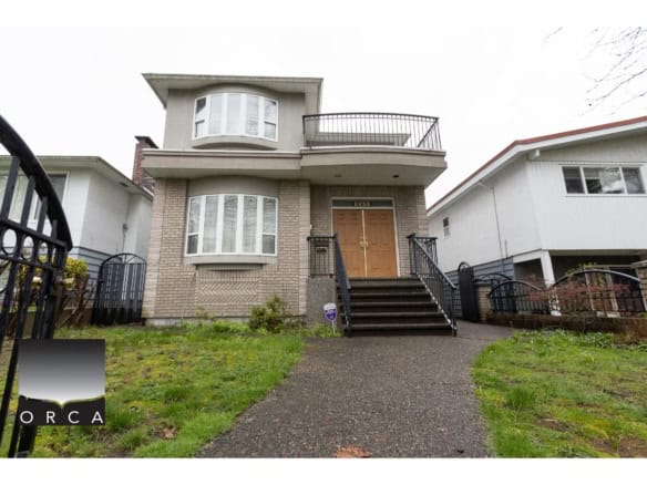 Modern family home for sale in Vancouver with spacious design, elegant brick façade, and inviting front entrance, ideal for real estate investors and homebuyers seeking prime Canadian properties.