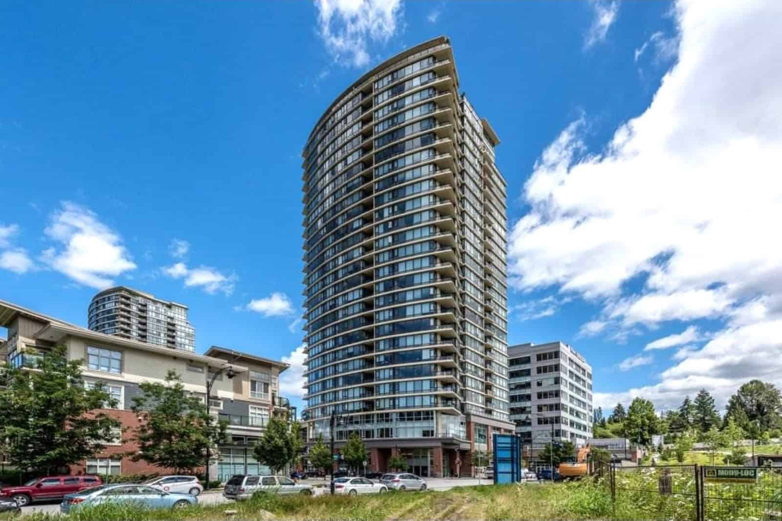 Luxury high-rise condo building in downtown Vancouver with modern architecture and panoramic city views.
