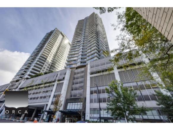 Luxury high-rise condominium building in downtown Toronto with modern glass architecture and city views, representing premium real estate opportunities.