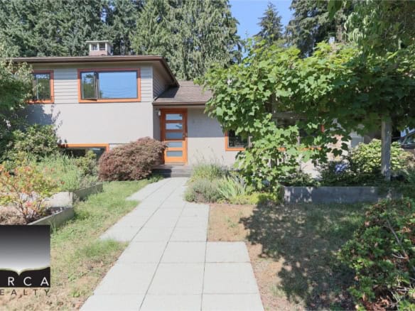 Modern Vancouver Westside home with lush landscaped garden, sleek exterior design, large windows, and welcoming entrance - perfect for buyers seeking premium real estate in Vancouver.