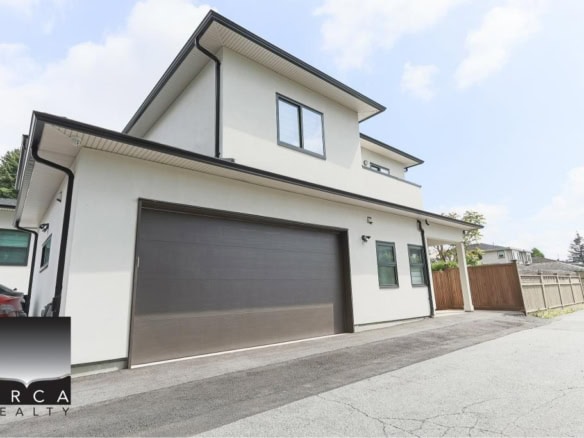 Modern white two-storey duplex with attached garage and black accents, located in a residential area. Ideal for homebuyers seeking contemporary architecture and spacious living in Ontario.