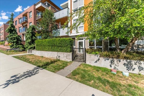 Bright Vancouver apartment complex with landscaped gardens and contemporary architecture, located at 101-7878 Granville Street.