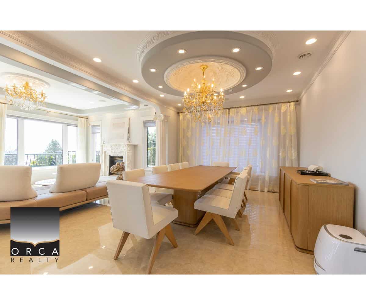 Luxury dining room with elegant chandelier, modern interior, large windows, and stylish furniture, showcasing upscale real estate by Orca Realty Inc. in en_CA style.