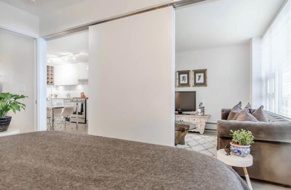 Spacious modern living room with large windows, stylish decor, and cozy seating, offering a bright and inviting atmosphere perfect for relaxing or entertaining guests.